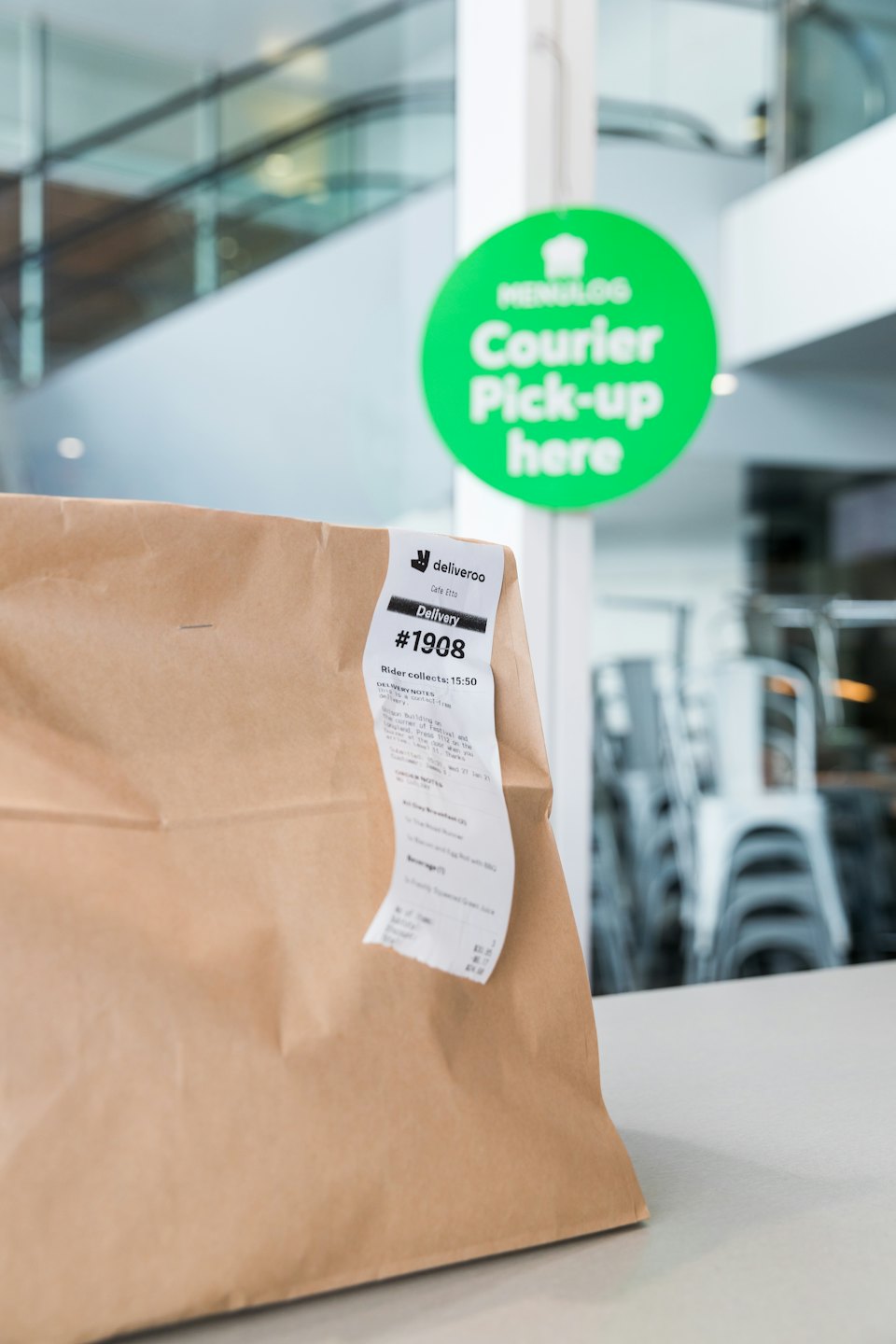 Deliveroo delivery bag with order details on a counter.